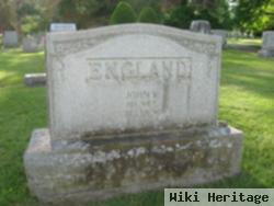 John W England