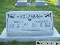 Troy K Holamon