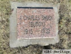 A. Charles "buddy" Shuck